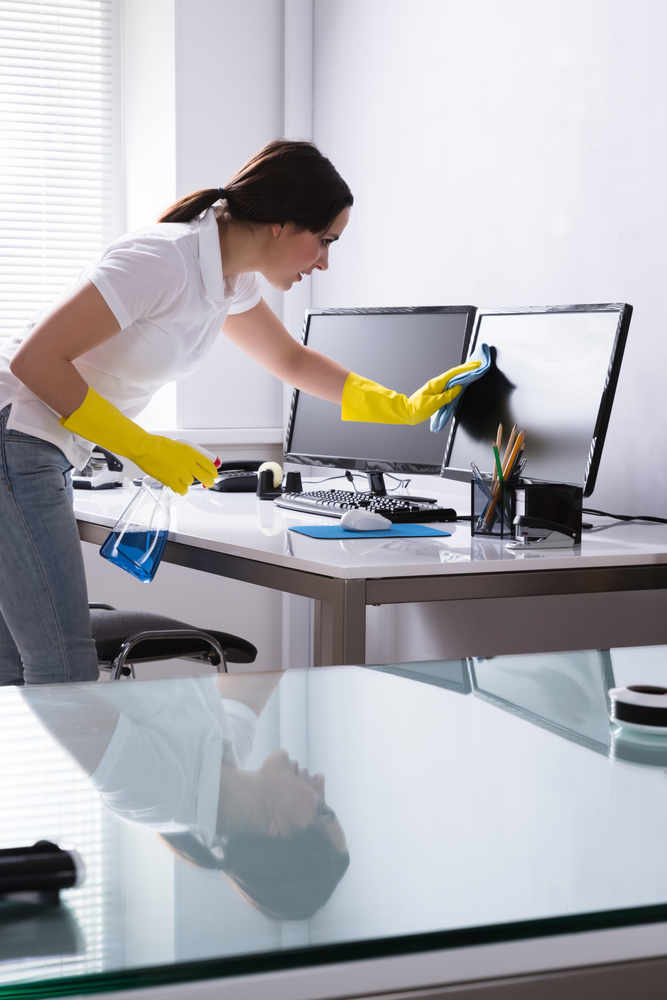 Janitorial Cleaning Service Woman Janitor Cleaning Desk in Office